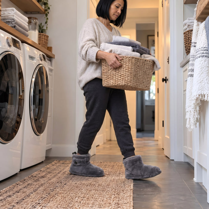 Customer carrying a laundry basket in La Nocte heated slipper boots