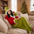 Woman curled up on her sofa in the La Nocte heated robe, holding the remote